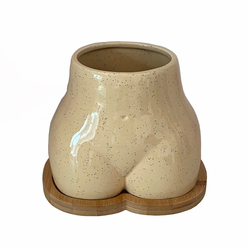 An Ornamental Ceramic Vase In The Shape Of A Human Hip