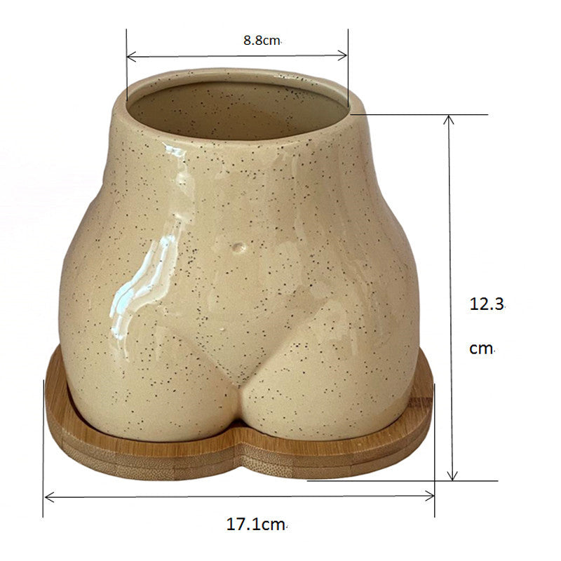 An Ornamental Ceramic Vase In The Shape Of A Human Hip