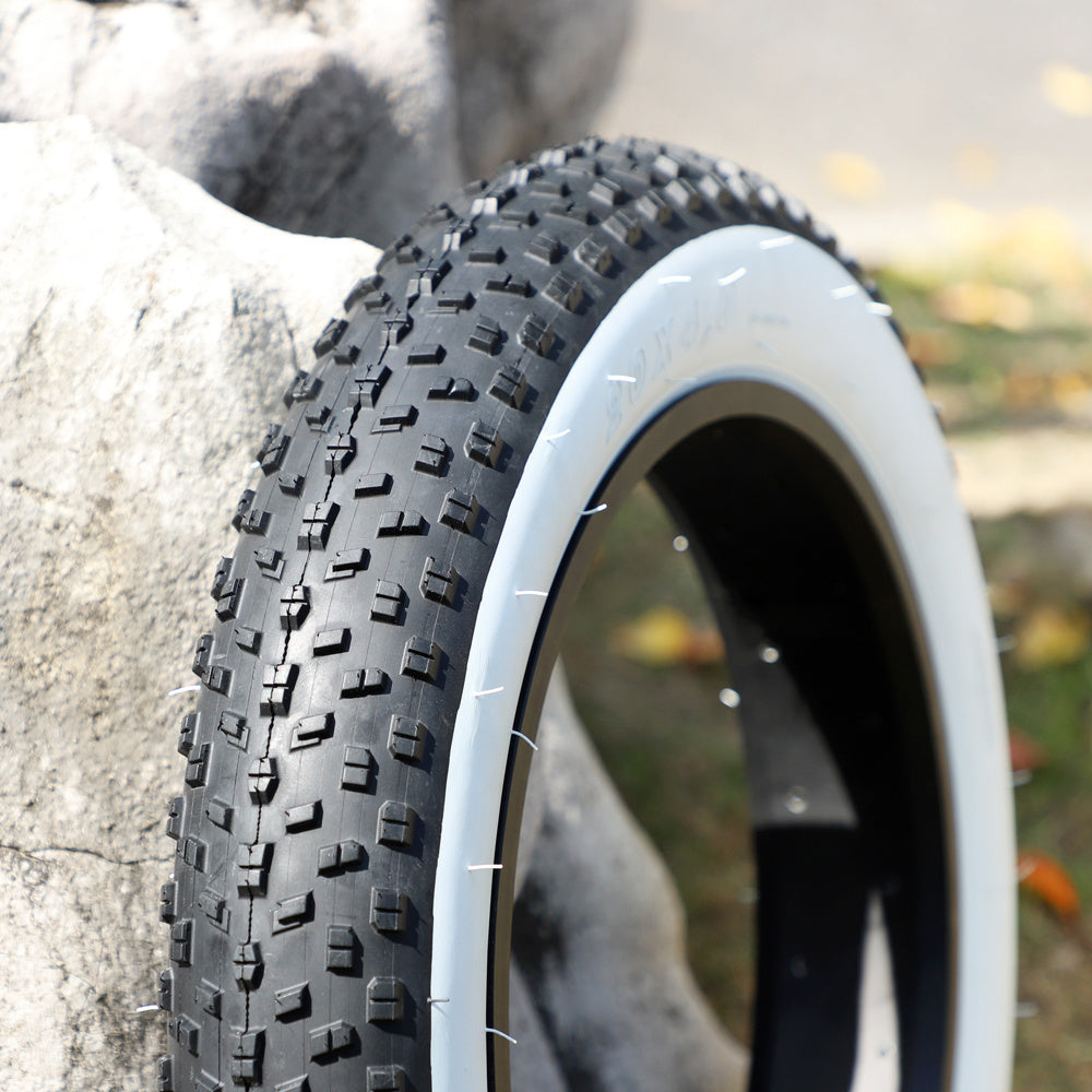 Folded Snow Tire With White Edge Outside The Beach